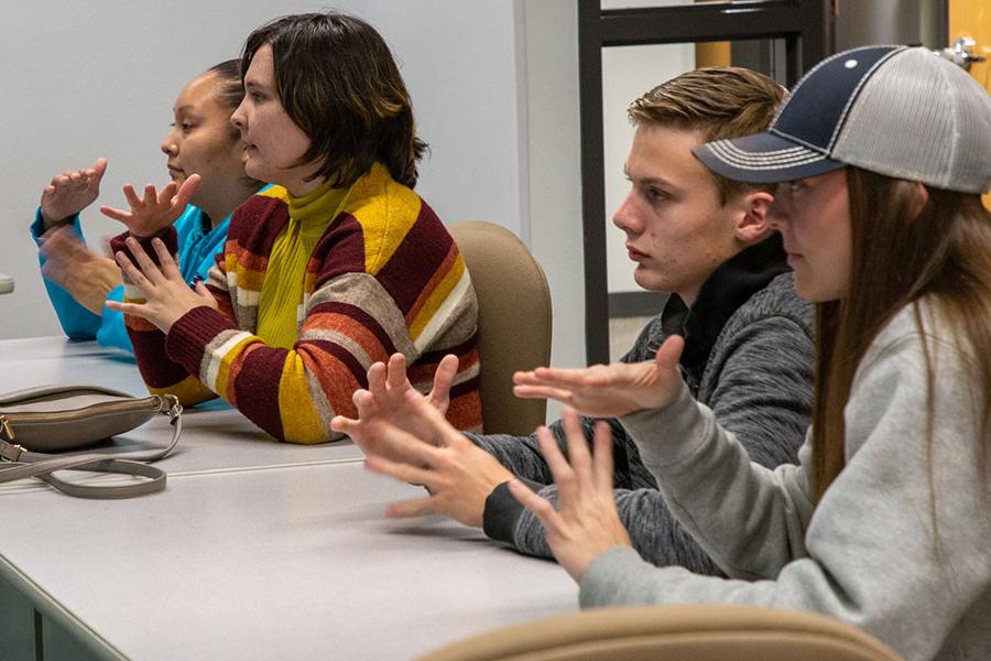 San Juan College students practicing American Sign Language hand signs in class